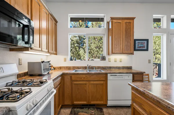 a kitchen with a sink stove top oven and microwave