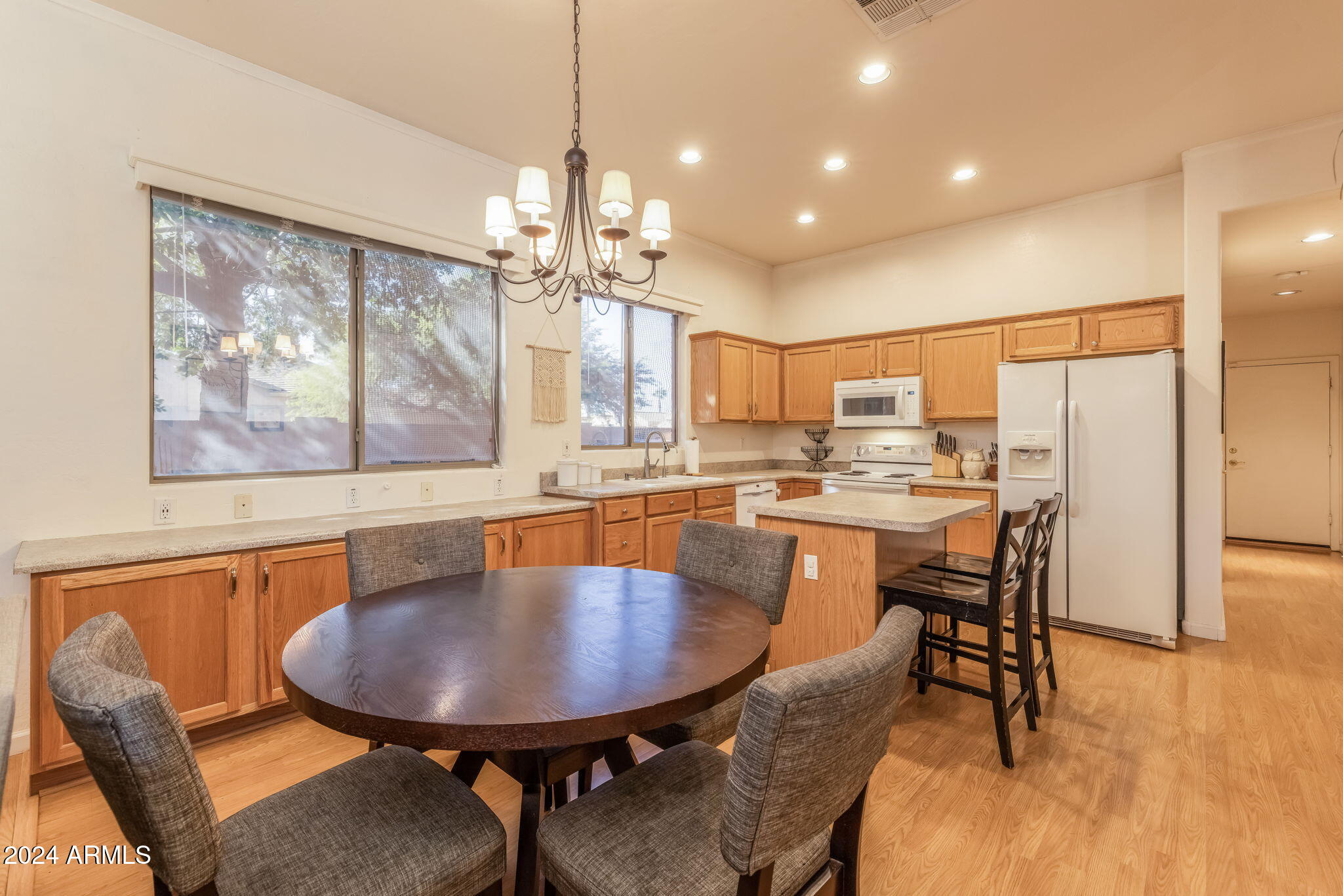 3355 East Los Altos Road Gilbert, AZ 85297 - Photo 12 of 34 a dining room with furniture a window and wooden floor