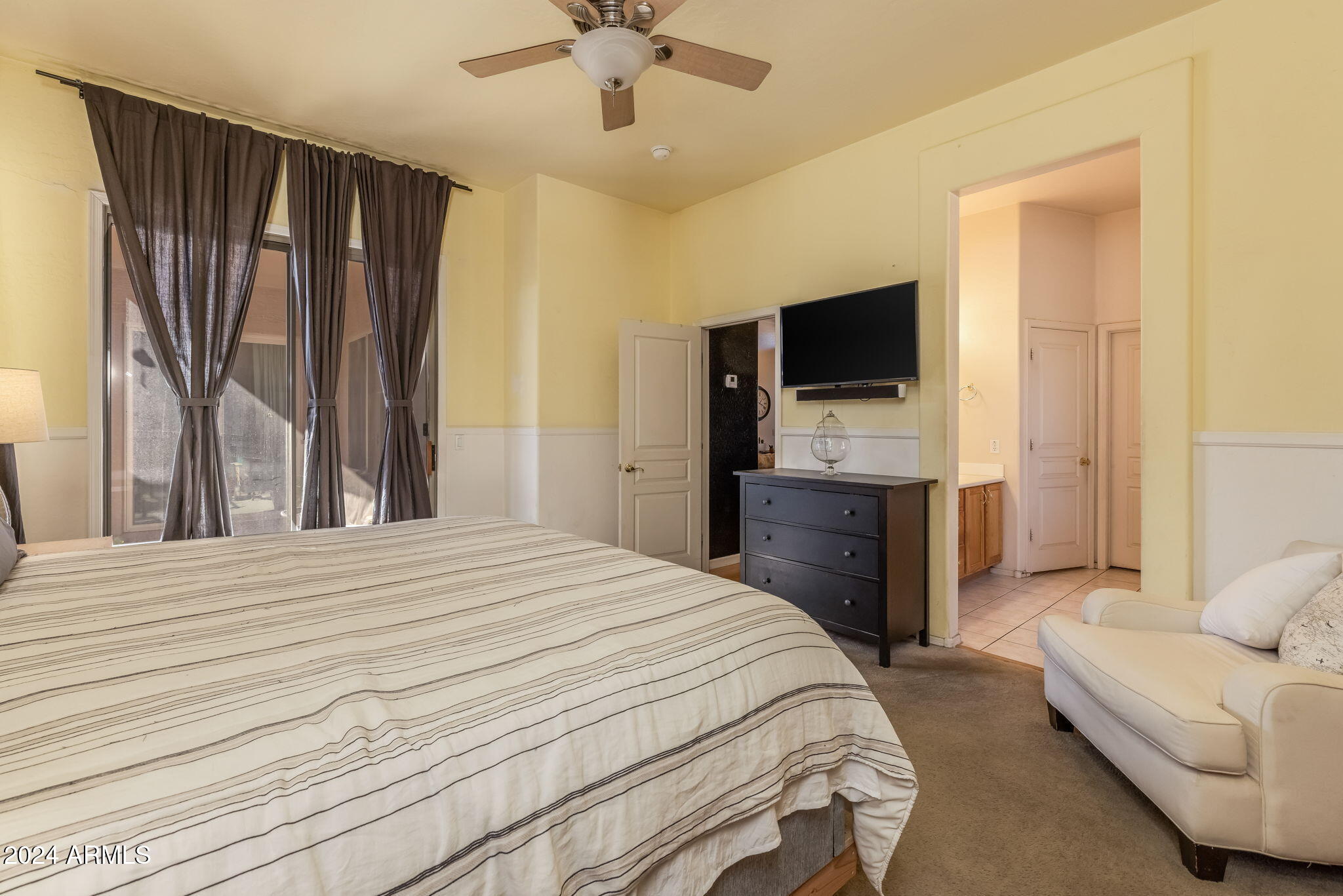 3355 East Los Altos Road Gilbert, AZ 85297 - Photo 18 of 34 a bedroom with a bed and a flat screen tv
