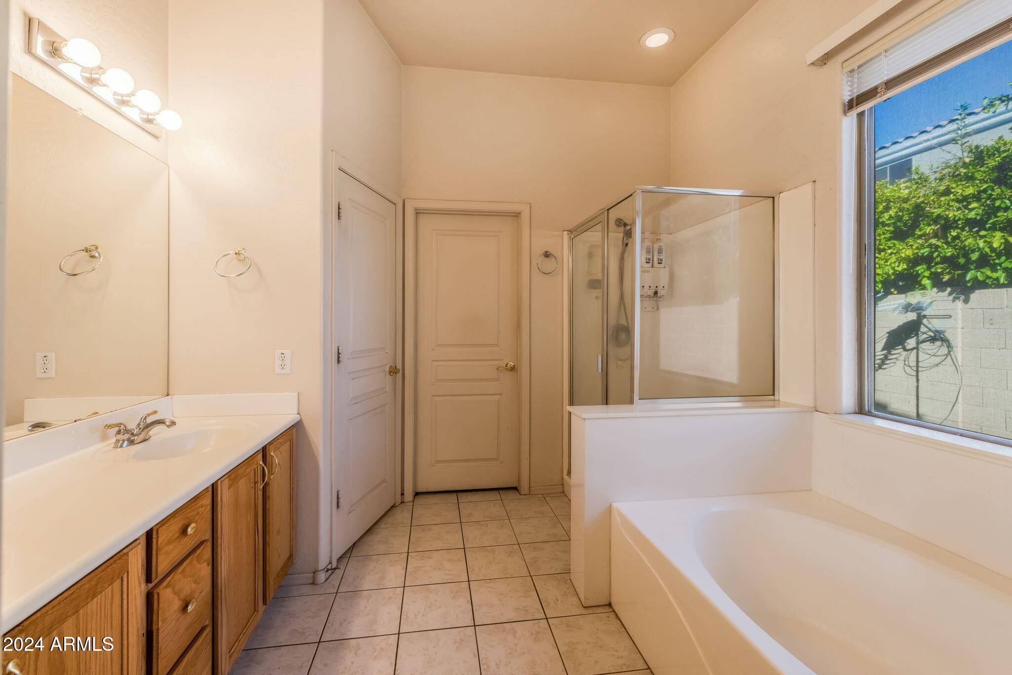 3355 East Los Altos Road Gilbert, AZ 85297 - Photo 19 of 34 a bathroom with a bathtub shower and a sink