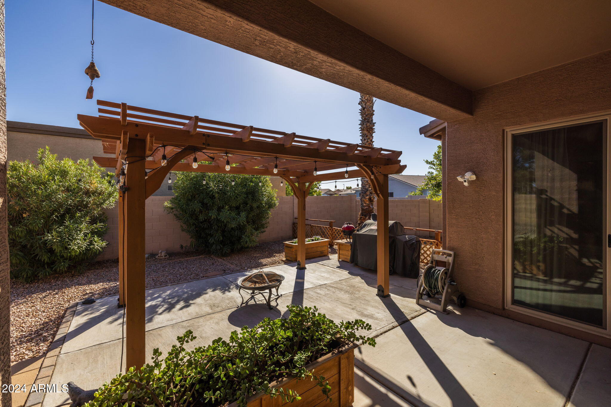 3355 East Los Altos Road Gilbert, AZ 85297 - Photo 29 of 34 a view of a patio with table and chairs potted plants