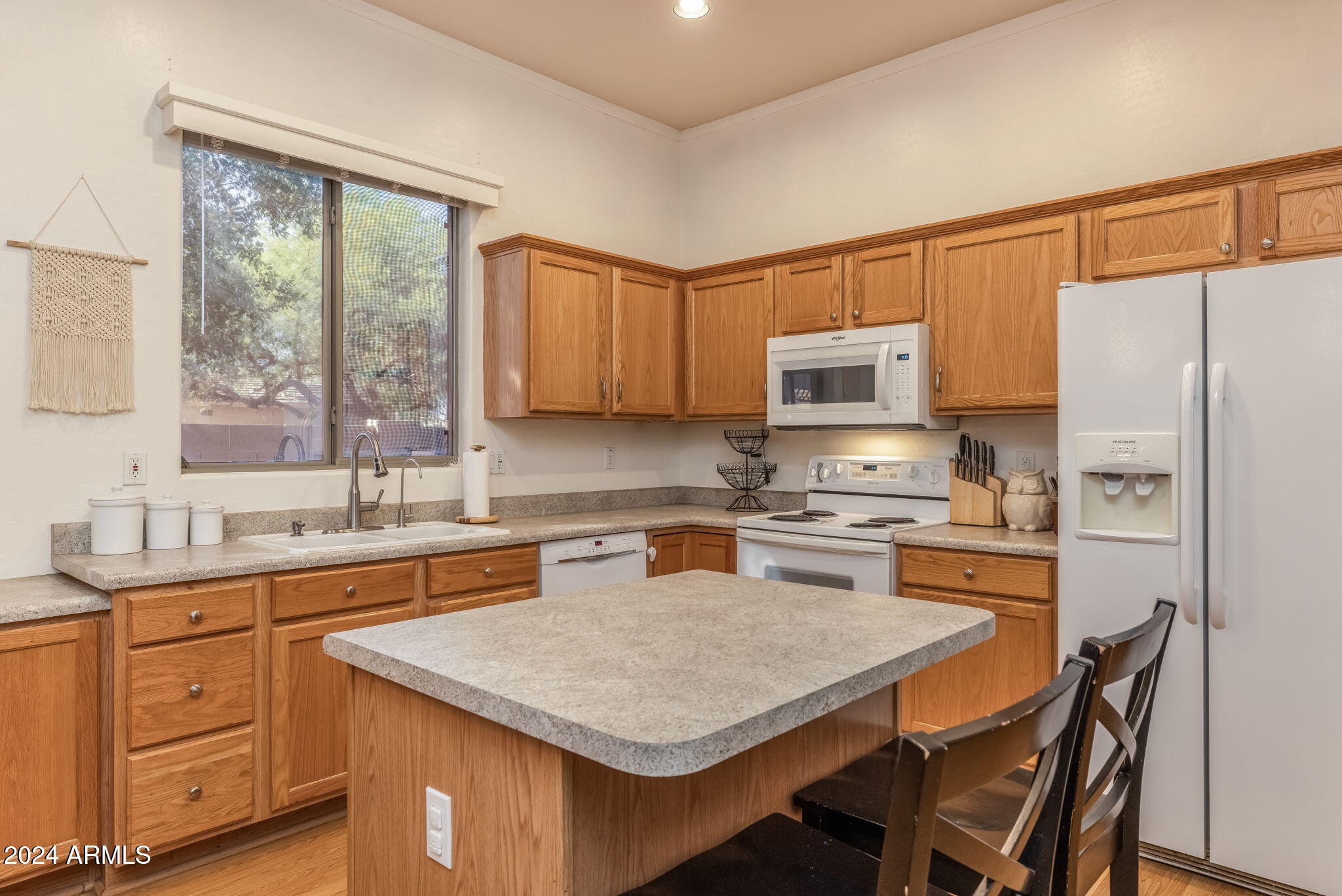 3355 East Los Altos Road Gilbert, AZ 85297 - Photo 9 of 34 a kitchen with stainless steel appliances granite countertop a stove top oven a refrigerator a sink and dishwasher with wooden floor