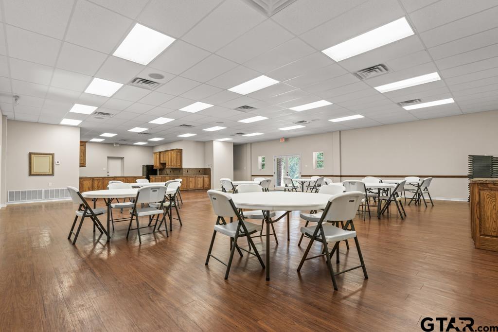 100 Lantana Road Gilmer, TX 75644 - Photo 26 of 30 a view of a dining hall with furniture and wooden floor