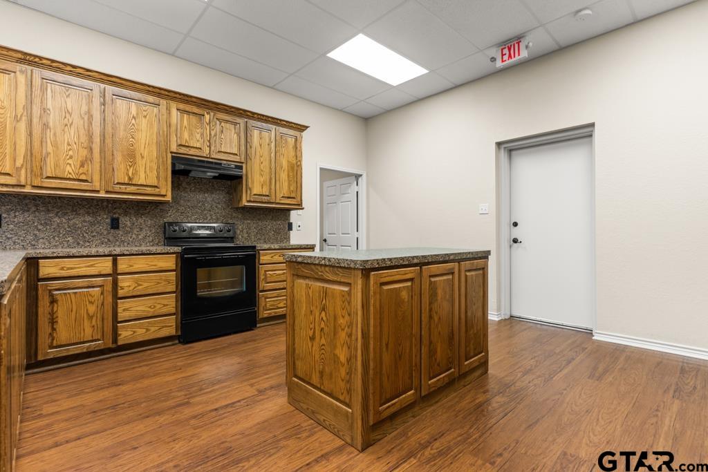 100 Lantana Road Gilmer, TX 75644 - Photo 28 of 30 a kitchen with stainless steel appliances granite countertop a stove a sink and a refrigerator