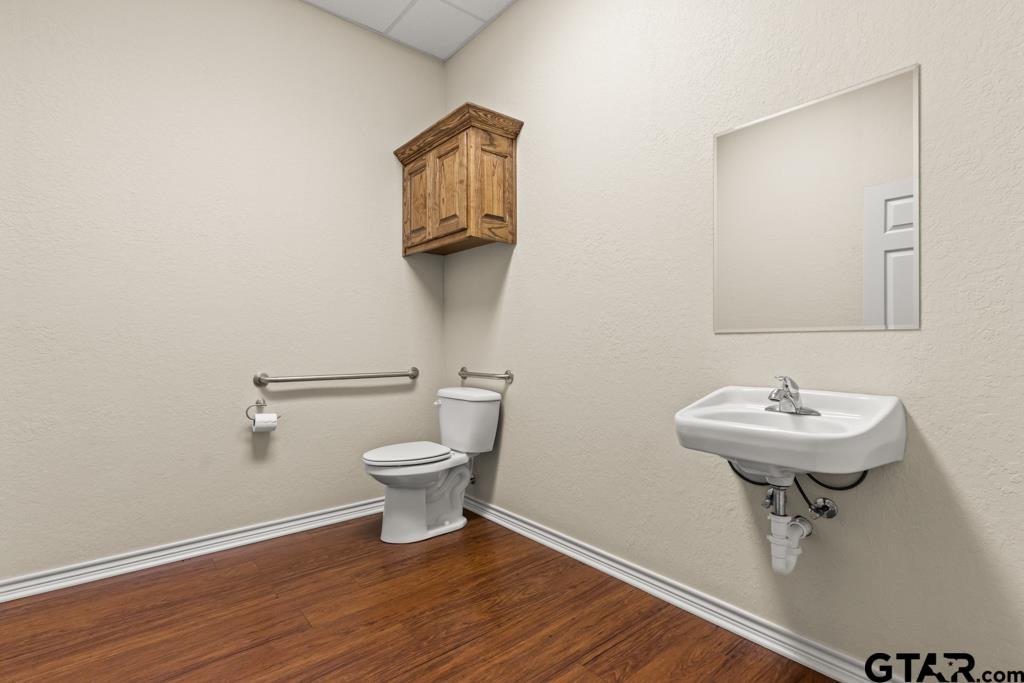 100 Lantana Road Gilmer, TX 75644 - Photo 29 of 30 a bathroom with a toilet a sink and mirror