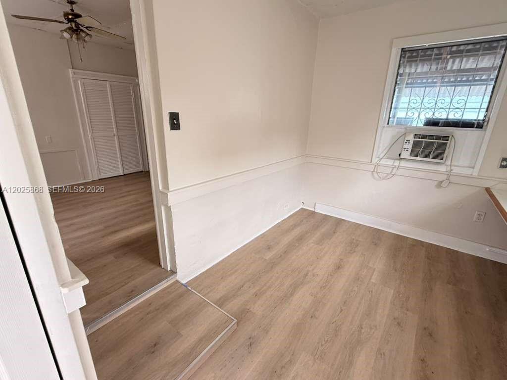 1919 Southwest 2nd Street, Unit B Miami, FL 33135 - Photo 5 of 12 a view of empty room with wooden floor and staircase