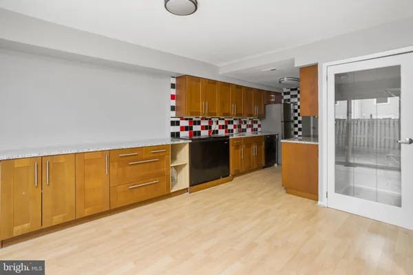 a kitchen with refrigerator and cabinets
