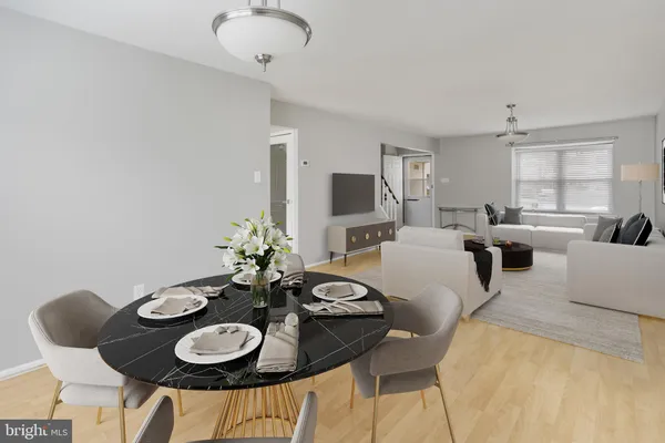 a view of a dining room with furniture a livingroom and wooden floor