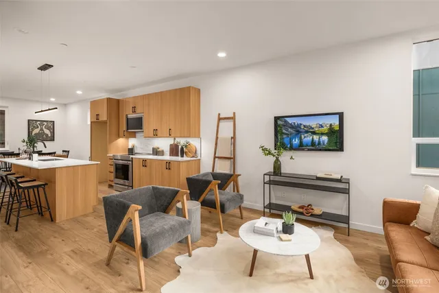 a living room with furniture kitchen and a table
