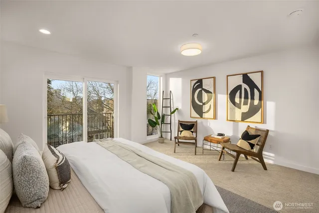 a bedroom with bed and a painting on the wall