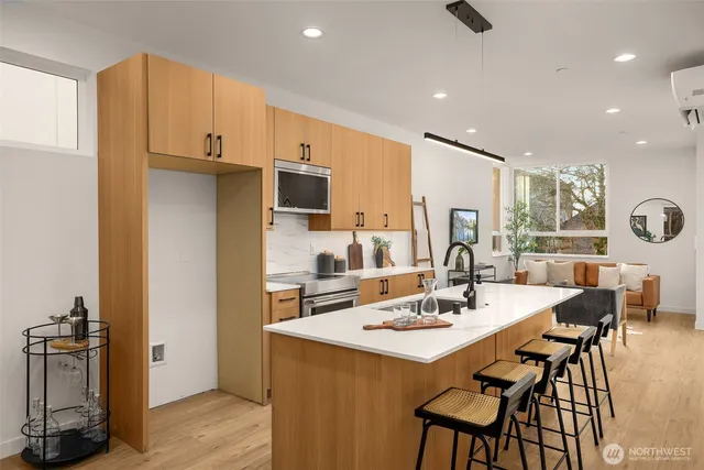 a kitchen with a dining table chairs and refrigerator
