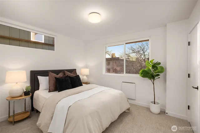 a bedroom with a bed and a potted plant
