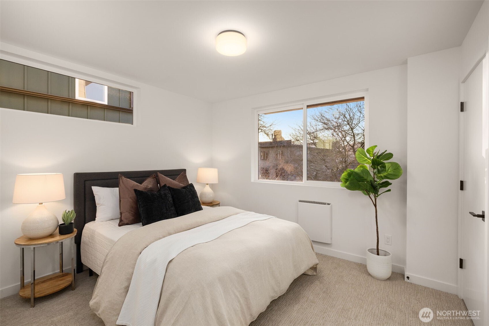 914 A 15th Avenue Seattle, WA 98122 - Photo 9 of 35 a bedroom with a bed and a potted plant