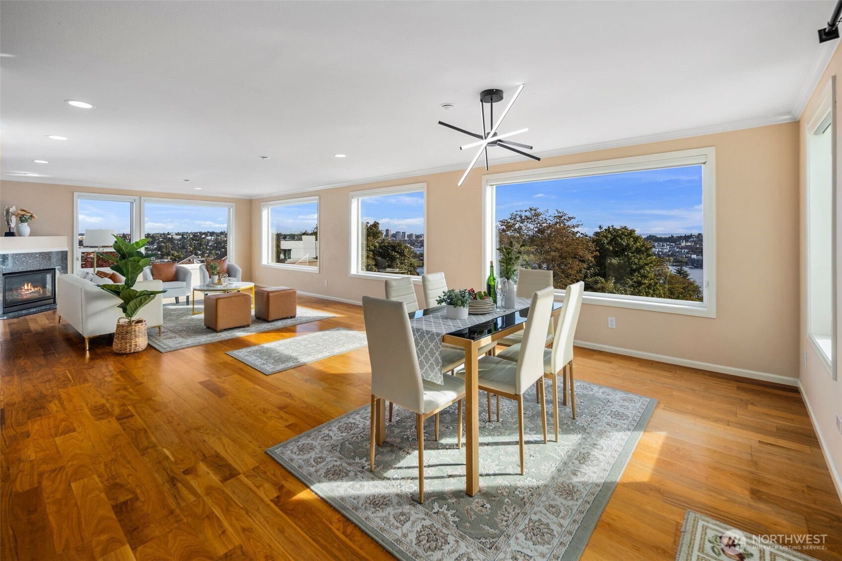 a dining room with wooden floor a chandelier a glass table and chairs