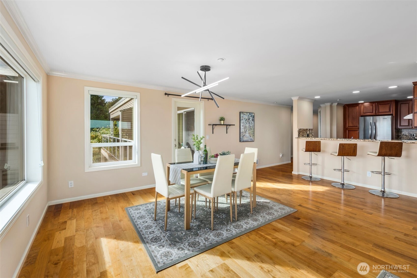 559 McGraw Street, Unit 402 Seattle, WA 98109 - Photo 13 of 39 a dining room with wooden floor and a floor to ceiling window