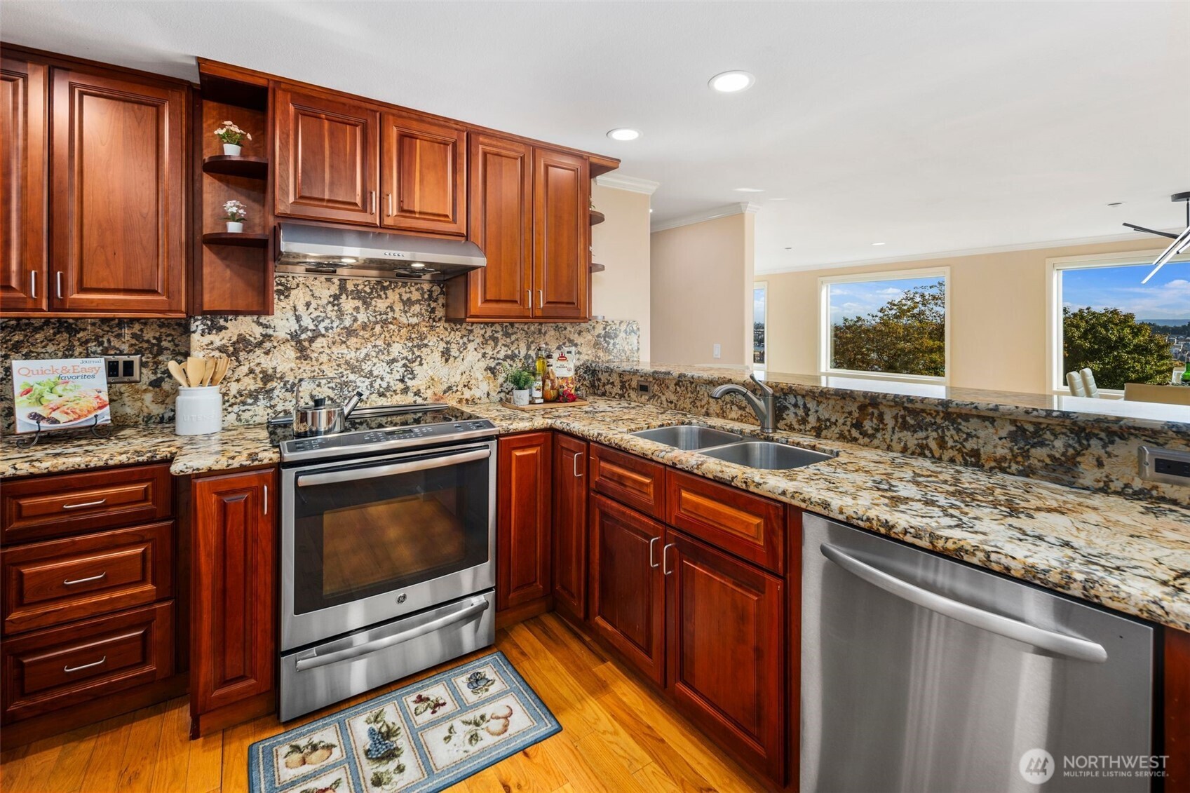 559 McGraw Street, Unit 402 Seattle, WA 98109 - Photo 15 of 39 a kitchen with stainless steel appliances granite countertop a sink stove and cabinets