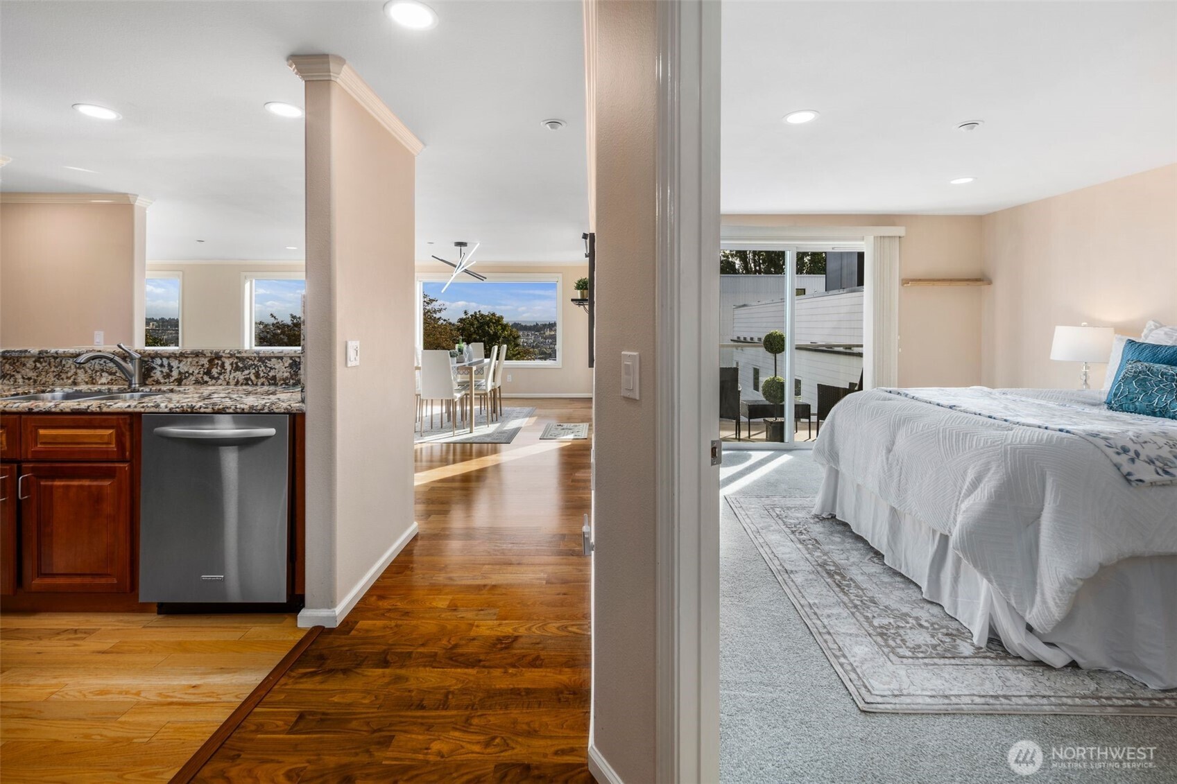 559 McGraw Street, Unit 402 Seattle, WA 98109 - Photo 17 of 39 a living room with kitchen view and a wooden floor