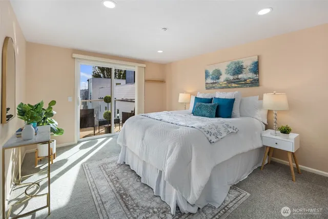 a bedroom with a large bed and a potted plant
