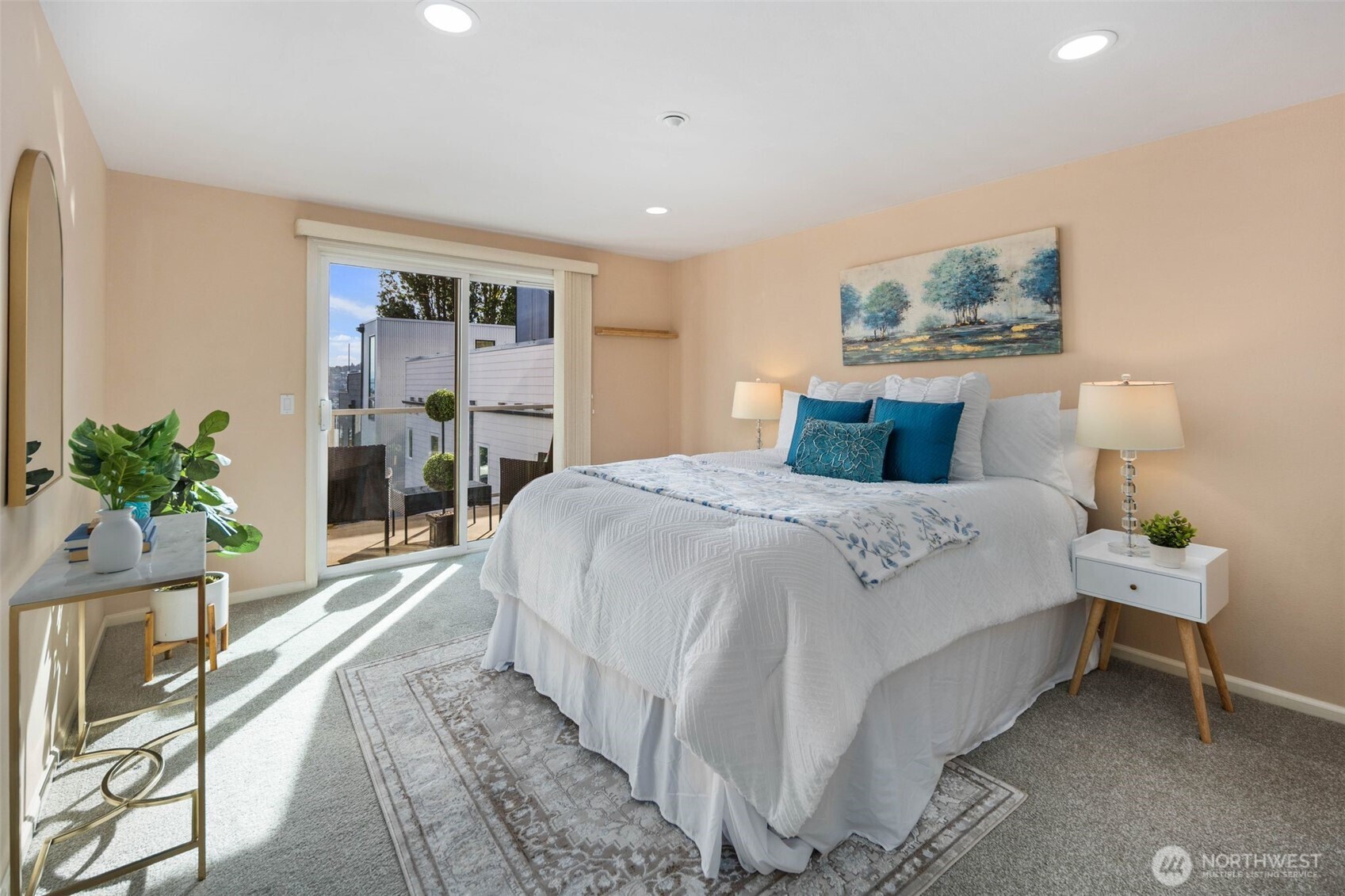 559 McGraw Street, Unit 402 Seattle, WA 98109 - Photo 18 of 39 a bedroom with a large bed and a potted plant