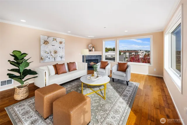 a living room with furniture and a dining table with wooden floor