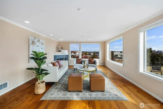 a living room with kitchen island granite countertop furniture and a potted plant