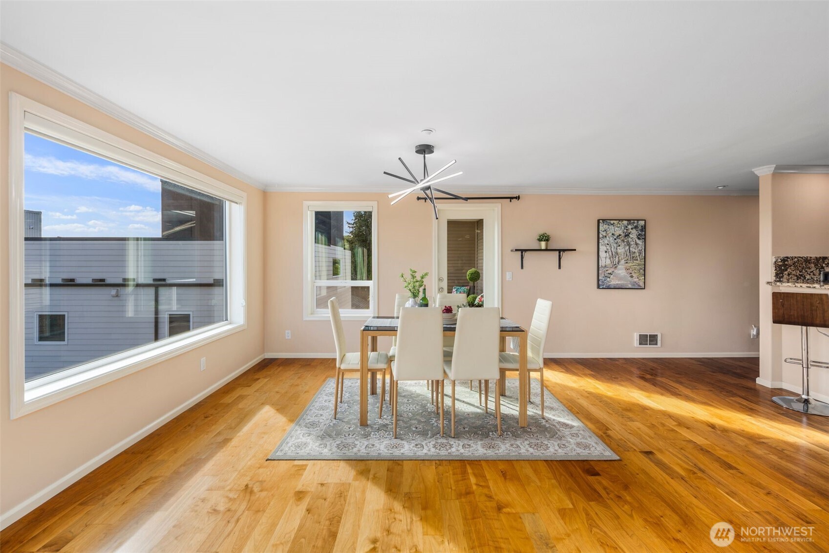 559 McGraw Street, Unit 402 Seattle, WA 98109 - Photo 10 of 39 a view of a dining room with furniture a rug and wooden floor
