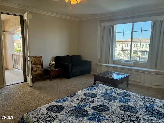 a living room with a couch and a dresser next to a window