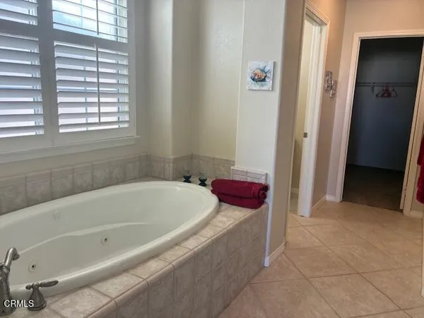 a bathroom with a tub and shower