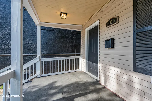 a view of a porch with wooden floor and fence