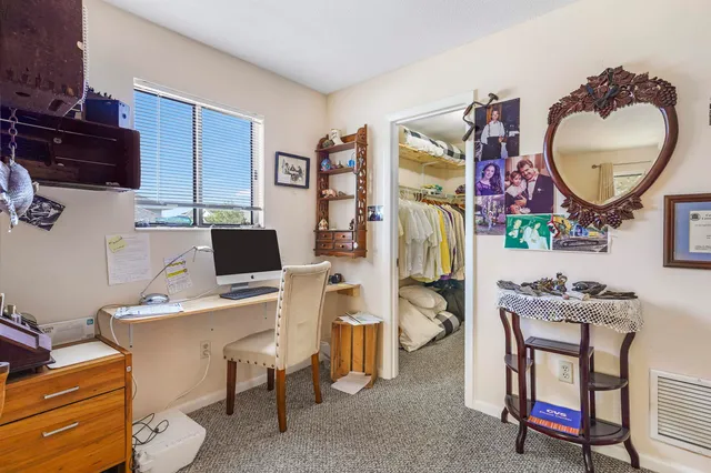 a workspace with furniture and a mirror