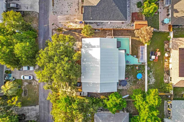 an aerial view of a house with a yard and potted plants