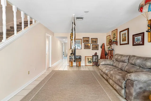 a living room with furniture and a dining table