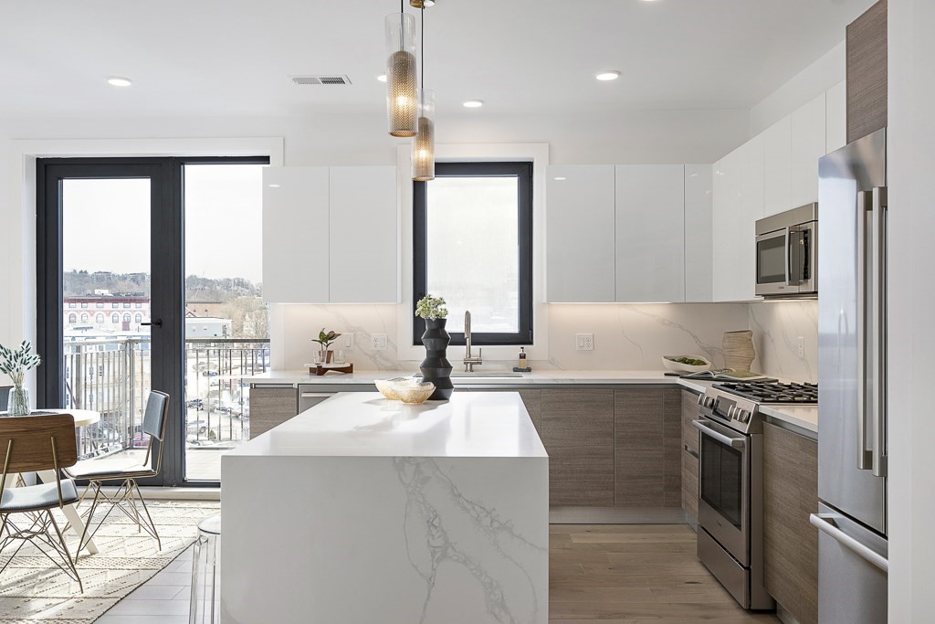 30 Penniman Road, Unit 507 Boston, MA 02134 - Photo 1 of 5 a kitchen with a sink stove and refrigerator