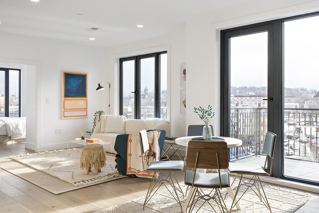 30 Penniman Road, Unit 507 Boston, MA 02134 - Photo 2 of 5 a living room with furniture and large windows