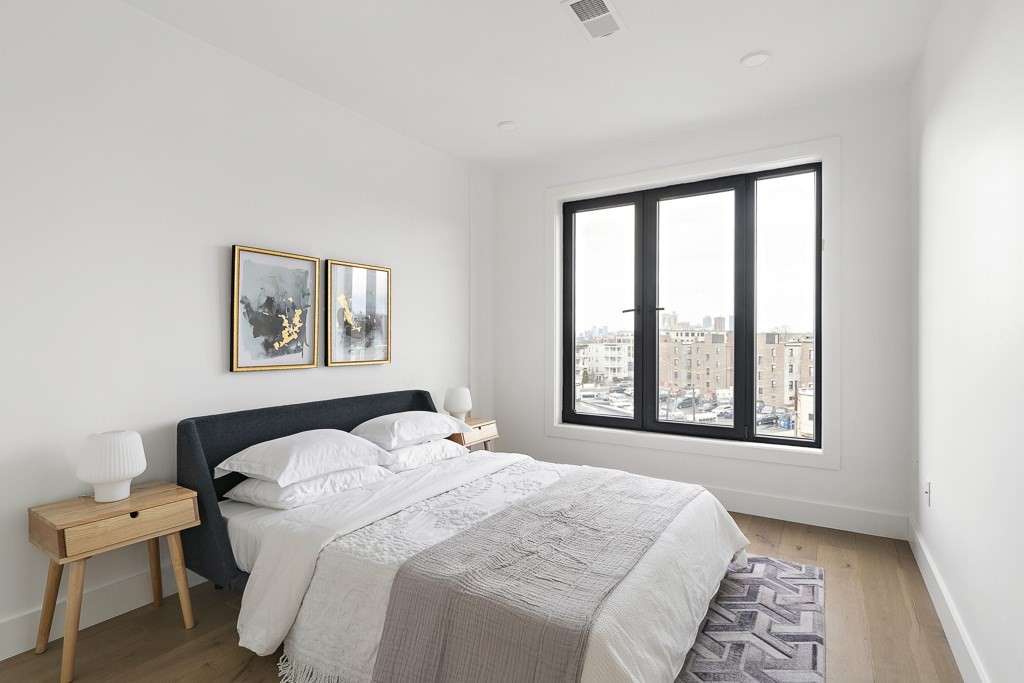 30 Penniman Road, Unit 507 Boston, MA 02134 - Photo 4 of 5 a bedroom with a bed and a window