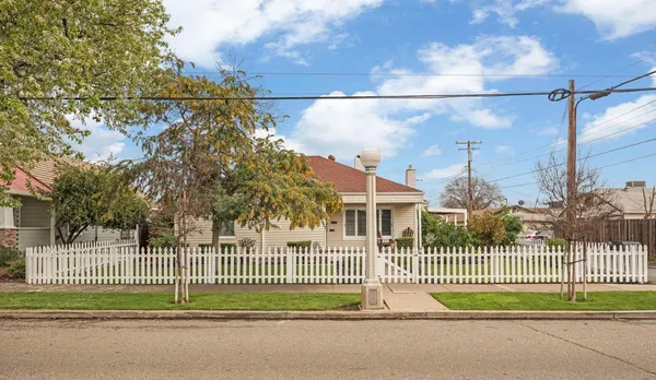a view of a brick house and a fence