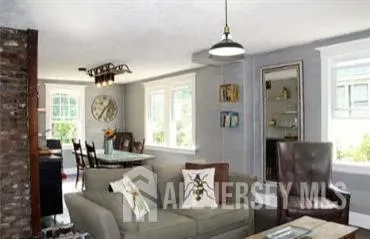 a living room with furniture and a chandelier