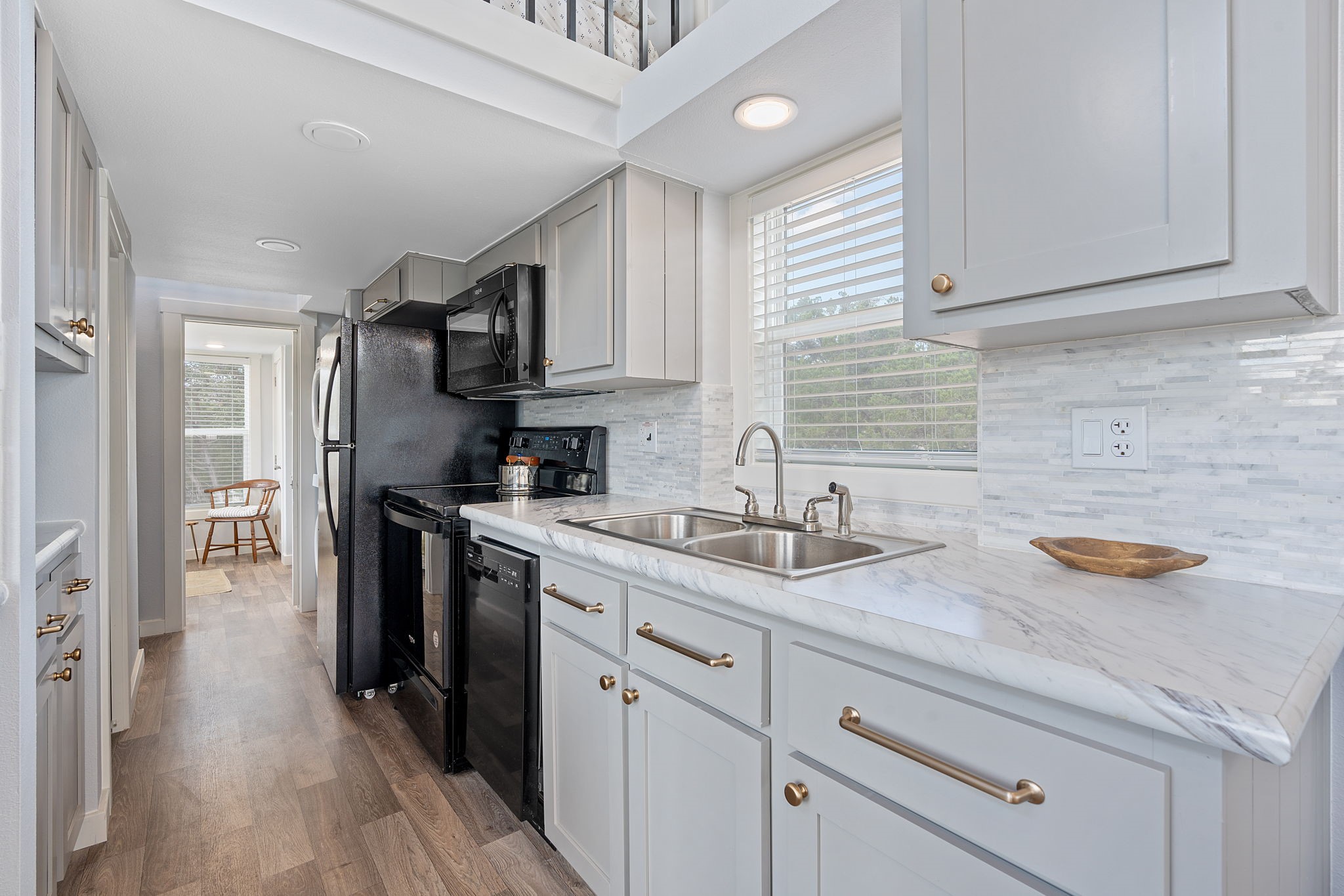 635 Ivean Pearson Road Lago Vista, TX 78645 - Photo 11 of 24 a kitchen with a sink a stove and cabinets