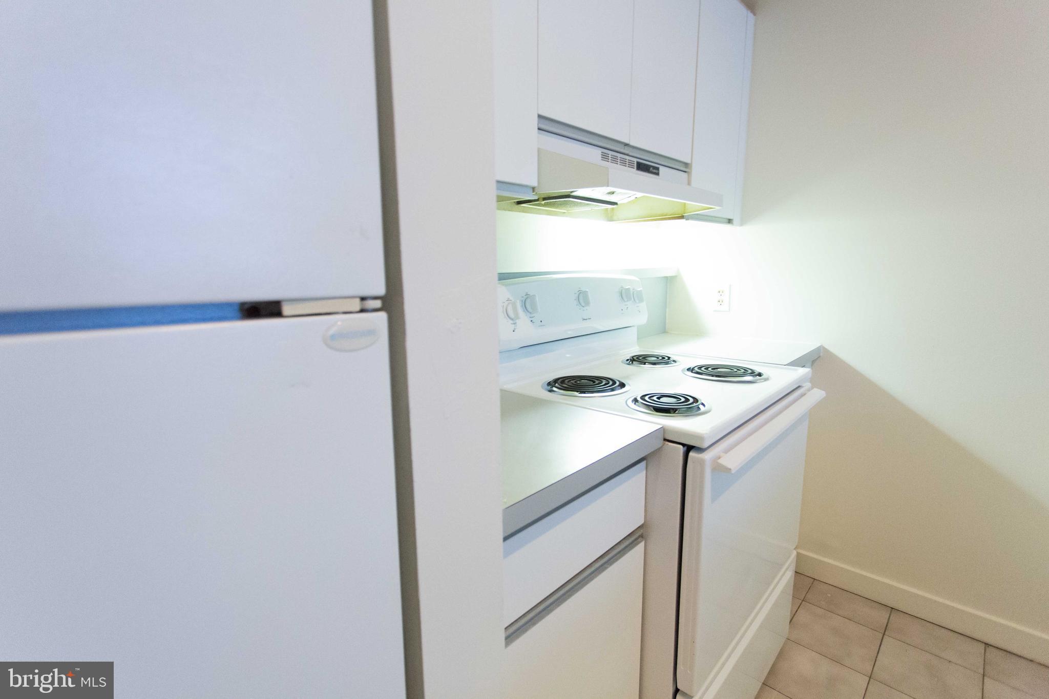 130-8 Arch Street, Unit 207 Philadelphia, PA 19106 - Photo 12 of 23 a kitchen with a sink a refrigerator and window