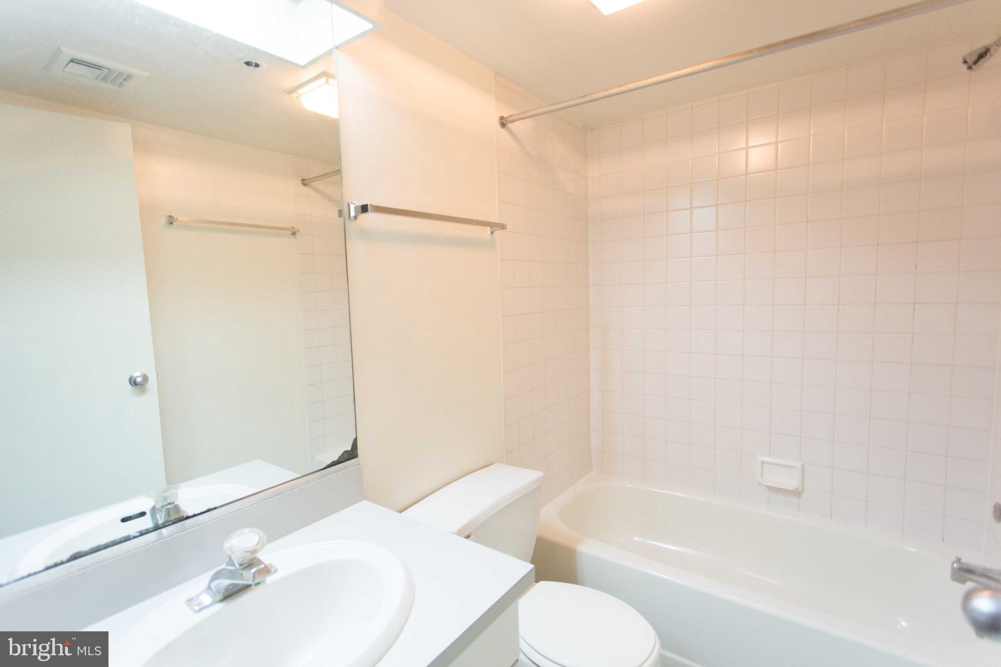 130-8 Arch Street, Unit 207 Philadelphia, PA 19106 - Photo 23 of 23 a bathroom with a bathtub shower sink and toilet