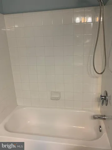 an empty room with closet and a bathroom