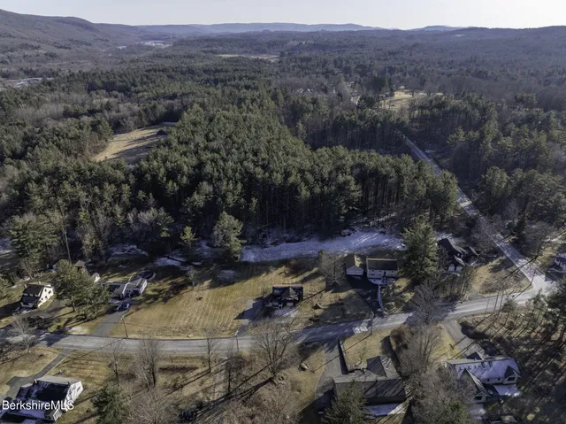 an aerial view of residential house and green space