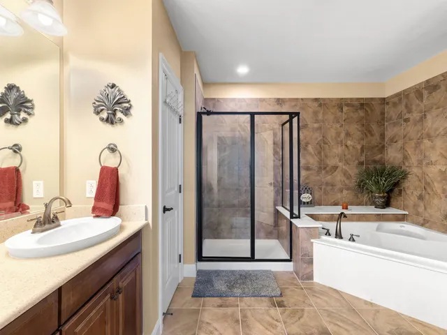 a bathroom with a tub sink and mirror