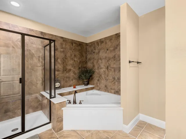 a bathroom with a bathtub and a shower