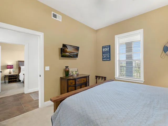 a bedroom with a bed and a television