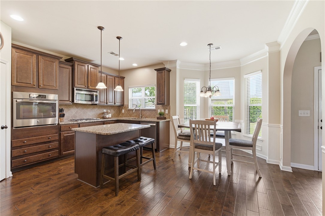 138 Buckland Drive Anderson, SC 29621 - Photo 12 of 49 This inviting kitchen and dining area features rich wood flooring and abundant natural light.