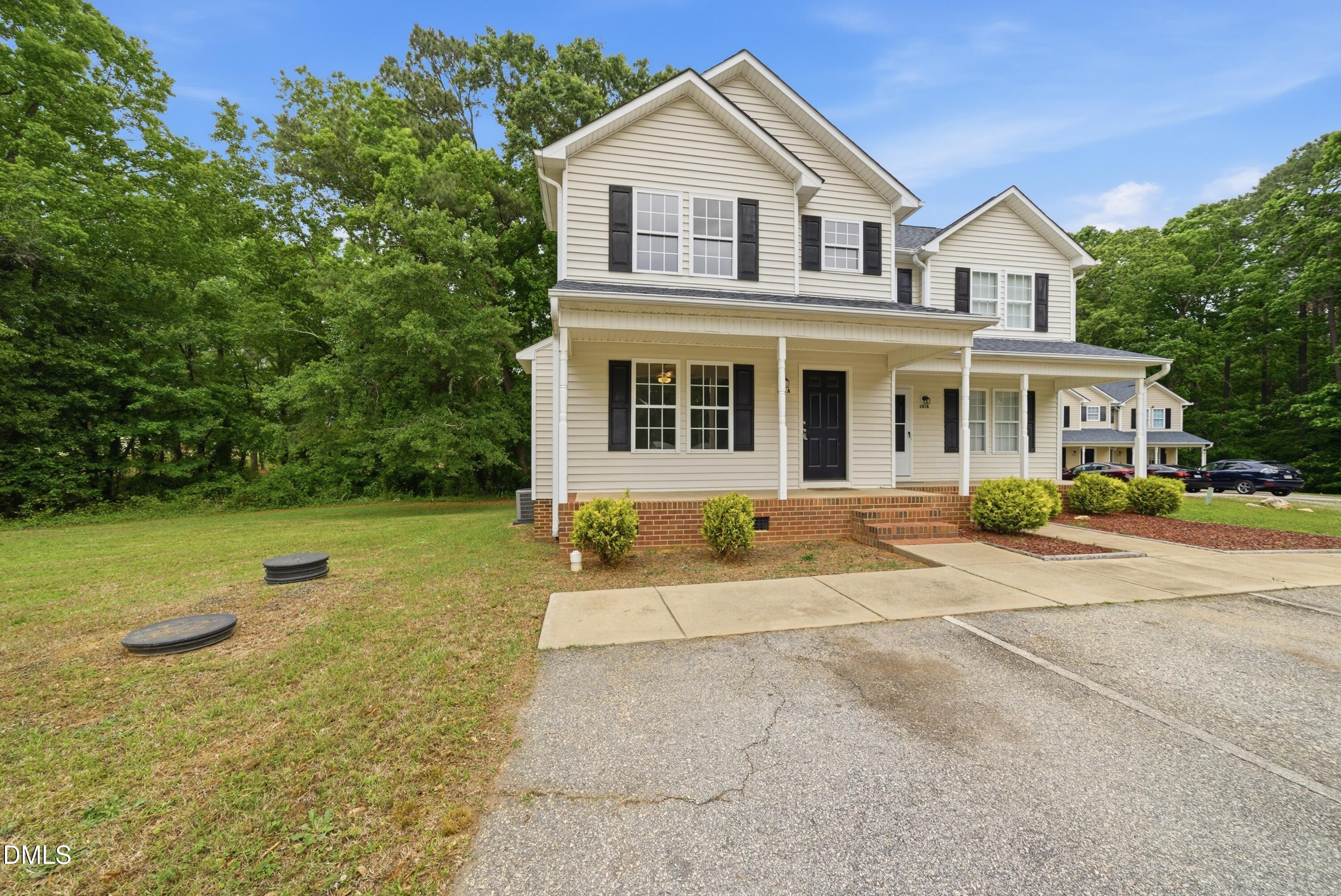 201 Tonylee Court, Unit A Raleigh, NC 27603 - Photo 3 of 30 a front view of a house with a yard and trees
