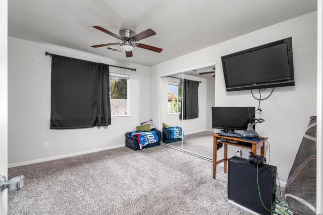 a working room with furniture and a flat screen tv