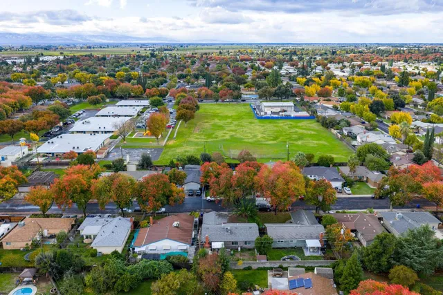 an aerial view of residential houses with outdoor space