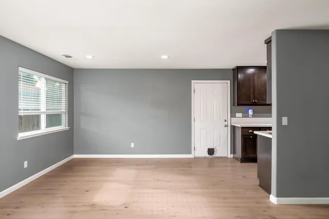 a view of a livingroom with a kitchen and a window